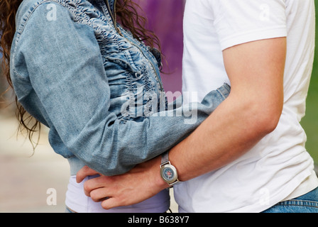Mid section view of a man and a woman embracing each other Stock Photo