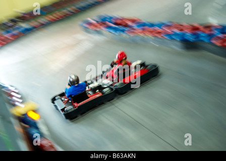 High angle view of two people go-carting on a motor racing track Stock Photo