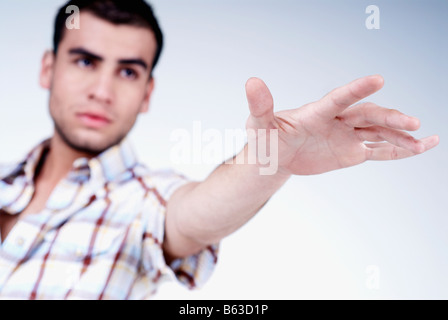 Close-up of a young man gesturing Stock Photo