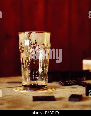 a color colour picture of a drained glass of beer, lager, stout or guiness in a bar Stock Photo