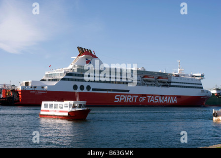 The Torquay ferry crossing the River Mersey in front of the Spirit of Tasmania 1 in Devonport Tasmania Stock Photo
