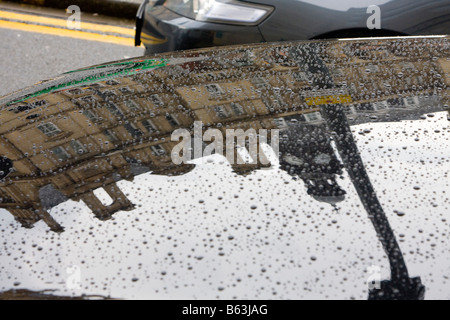 Old Post Office reflected in water  on cart bonet Leeds city centre UK Stock Photo