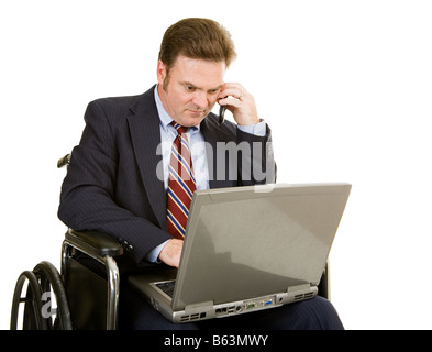 Mature businessman in wheelchair using his laptop and talking on the phone Isolated on white Stock Photo