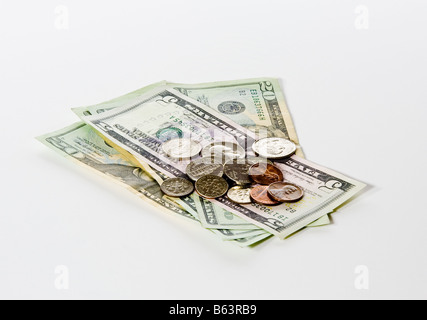 Pile of US currency notes and coins loosely laid out on the table Stock Photo