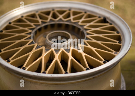 A custom gold rim with polished silver lip tire removed Shallow depth of field Stock Photo