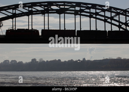 Freight train crossing the river Rhine, Cologne, North Rhine-Westphalia, Germany. Stock Photo