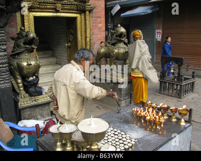 Man selling offerings outside the Akash Bhairab hindu temple in Indra Chok Road, Indra Chowk, Kathmandu, Bagmati, Nepal, Asia Stock Photo