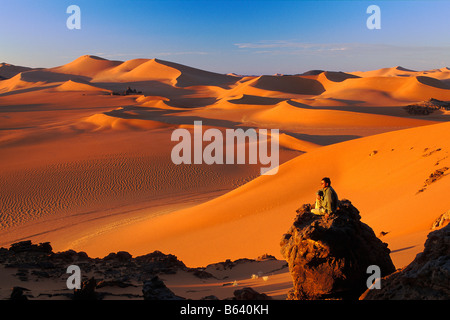 Algeria, near Djanet. Sand dunes and rocks. Tourist enjoying view. Sahara Desert. Stock Photo