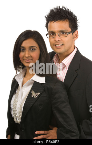 Young modern asian couple in suits isolated on white Stock Photo