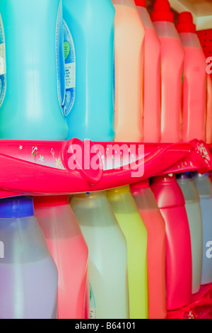 Fabric softener bottles in different colors on a Supermarket shelf. the shelf itself has a heart-like symbol on it. Stock Photo