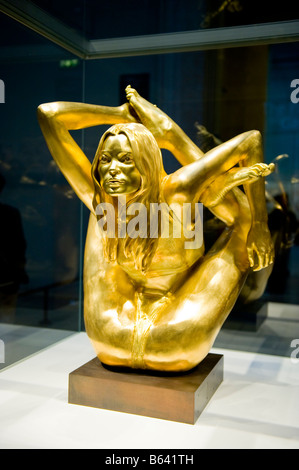British Museum stunning modern art statue in gold  of The Siren , Kate Moss , by Marc Quinn pretty teenage girl in yoga position Stock Photo