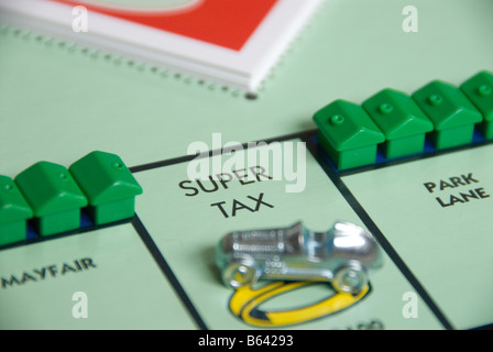 Tax on a Monopoly board game with houses Stock Photo