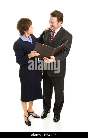 Attractive mature business man and woman going over a report Full body isolated on white Stock Photo