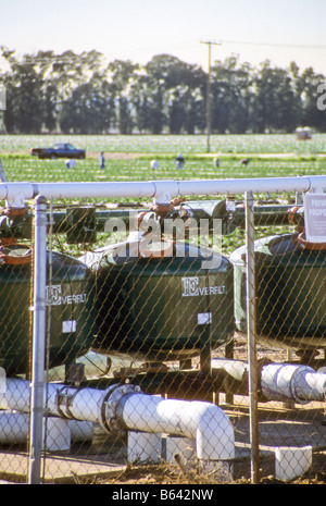 Chemical tanks release fertilizer into water used to irrigate fields. Stock Photo