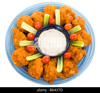 Delicious buffalo chicken wings with ranch dressing celery and grape tomatoes Isolated on white with clipping path Stock Photo