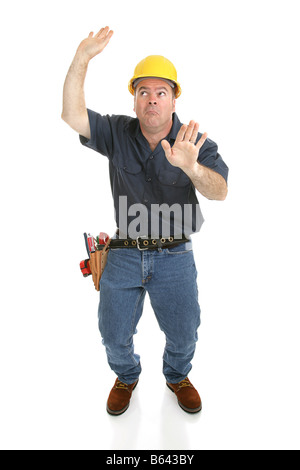 Construction worker trapped in imaginary box Full body isolated on white Stock Photo