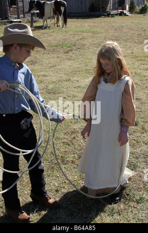 A young girl has been roped by a cowboy on a ranch in Texas Stock Photo