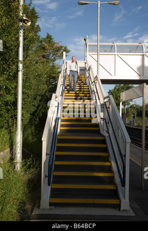 Steps leading to passenger bridge over railway line. Stock Photo