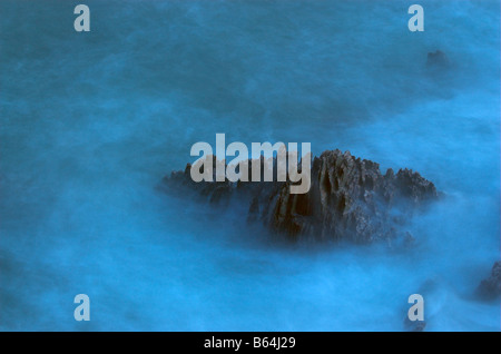 Waves breaking over rocks on the Gower peninsula Stock Photo