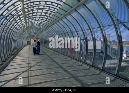 Asian couple in the footbridge tunnel of Poplar DLR station London docklands England Stock Photo