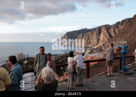 Tourists at the Mirador de Archipenque overlooking the cliffs of Los Gigantes in Tenerife Canary Islands Spain Stock Photo