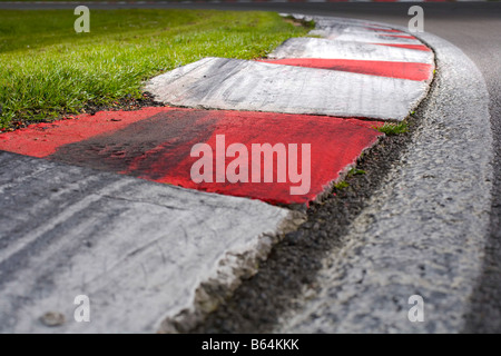 Race Track kerb with tyre marks. Red and White kerbstones on a corner curve of Brands Hatch motor race circuit. Stock Photo