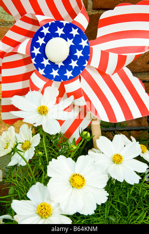 A flower box in Aspen, Colorado includes a Stars and Stripes pinwheel to celebrate July 4th, America's Independence Day. Stock Photo