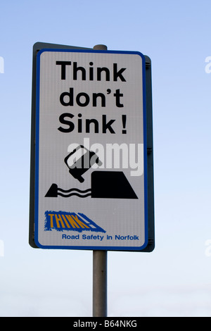 'Think don't Sink' sign warning of soft verges and flooding on B1100 across the Hundred Foot Washes near Welney, Norfolk UK Stock Photo