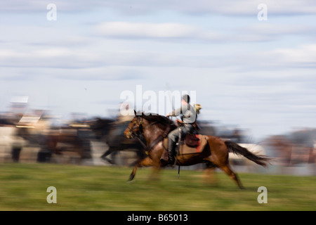 A Civil War Battle Renactor races his horse across the field at the renactment of the Battle of Berryville. Stock Photo