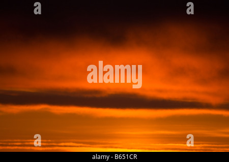 summer sunset glowingly reflected in clouds over a sea ice free Beaufort Sea 1002 area of the Arctic National Wildlife Refuge, North Slope, Alaska Stock Photo