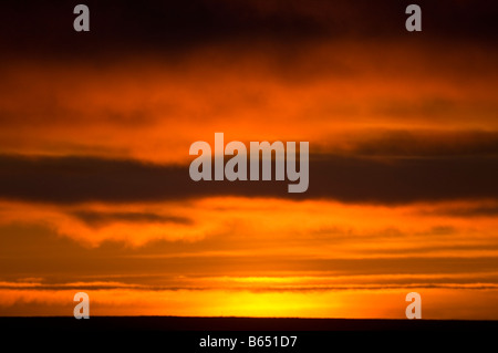 summer sunset glowingly reflected in clouds over a sea ice free Beaufort Sea 1002 area of the Arctic National Wildlife Refuge, North Slope, Alaska Stock Photo