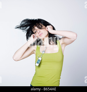 portrait of a young woman listening music on isolated background Stock Photo