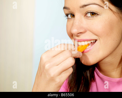 Young Woman Eating Carrot Sticks Model Released Stock Photo