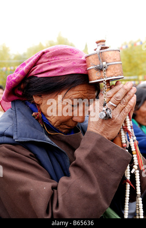 Mainly the older generation in Ladakh is often being seen praying They repeat their Om Mani Padme hum over and over again Stock Photo