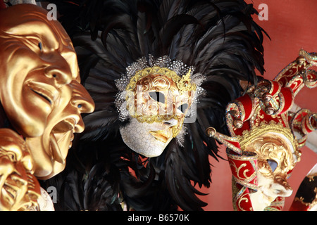 Venetian masks with black feathers on a red background Stock Photo