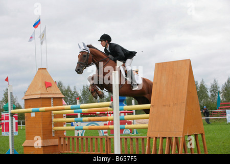 Horse jumping barrier during equestrian competition Stock Photo
