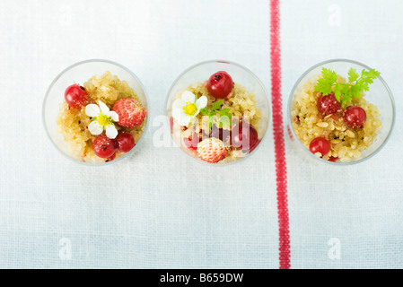 Bowls of quinoa and fruit Stock Photo