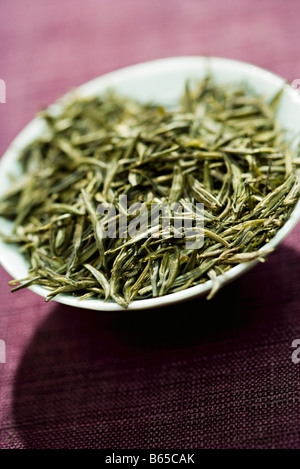 Dry tea leaves in bowl, close-up Stock Photo