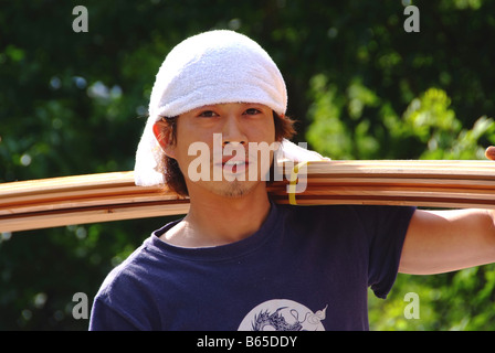 A young Japanese carpenter building a house Stock Photo