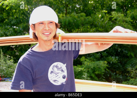 A young Japanese carpenter building a house Stock Photo