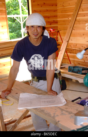 A young Japanese carpenter building a house Stock Photo