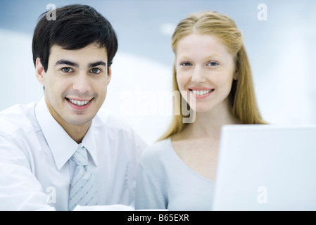 Professionals side by side smiling at camera, portrait Stock Photo