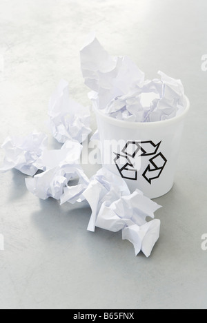 Crumpled paper overflowing recycle bin, close-up Stock Photo
