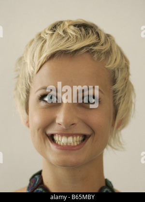 Portrait of a young blonde woman with a toothy smile Stock Photo