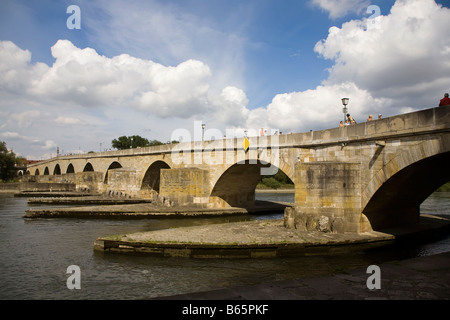 The old stone bridge built in the Middle Ages across the river Danube Regensburg Germany Stock Photo