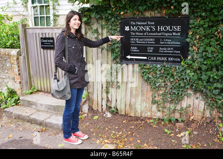 A young woman posing for a photograph outside of Monk's House (Home of Leonard and Virginia Woolf until 1969) Stock Photo