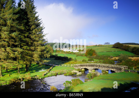 Bellever in Devon with a modern bridge crossing the East Dart River besides the remains of the ancient clapper bridge Stock Photo