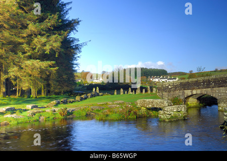 Bellever in Devon with a modern bridge crossing the East Dart River besides the remains of the ancient clapper bridge Stock Photo