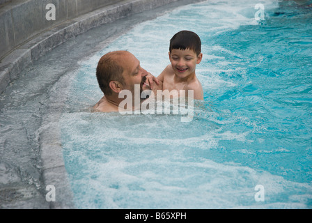 Father and son having fun in the pool at Cassiopeia Therme Badenweiler Germany by Charles W. Lupica Stock Photo