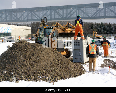 construction workers on a job site in winter Stock Photo